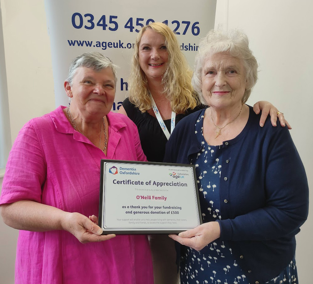 Joan accepting a certificate of appreciation from Age UK Oxfordshire's CEO