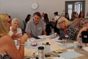 Dementia Adviser talking to her session group around a table