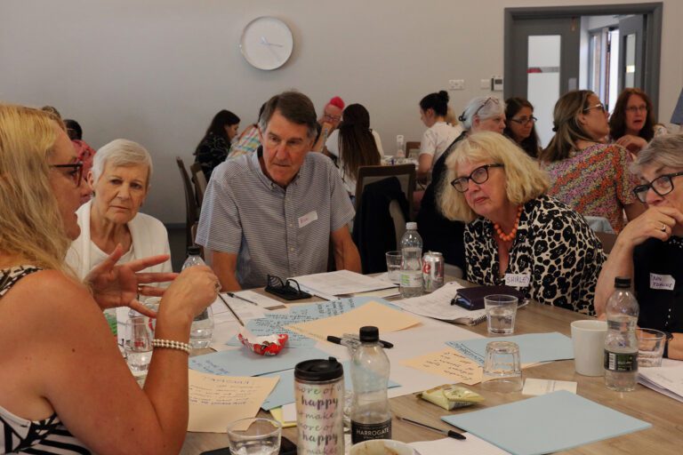 Dementia Adviser talking to her session group around a table