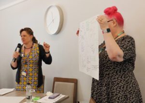 Two ladies taking the participants through their group's findings