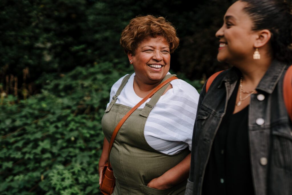 Two ladies laughing outside