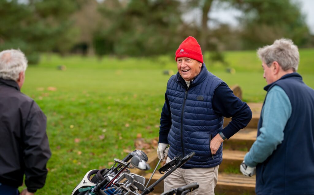 Three men getting some exercise by playing golf