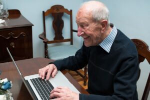 Senior gentleman working at his laptop